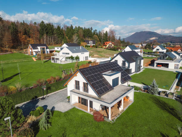istock Low aerial close view new dense rural housing development, mostly grey roofing, some green landscaping, young trees. Modern homes with flat roof 1831282043