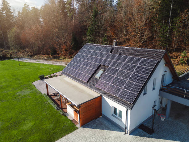 istock Low aerial close view new dense rural housing development, mostly grey roofing, some green landscaping, young trees. Modern homes with flat roof 1831282565