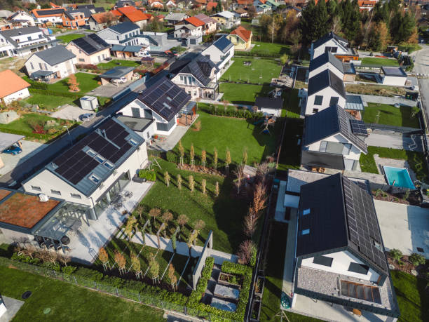 istock Low aerial close view new dense rural housing development, mostly grey roofing, some green landscaping, young trees. Modern homes with flat roof 1831282582