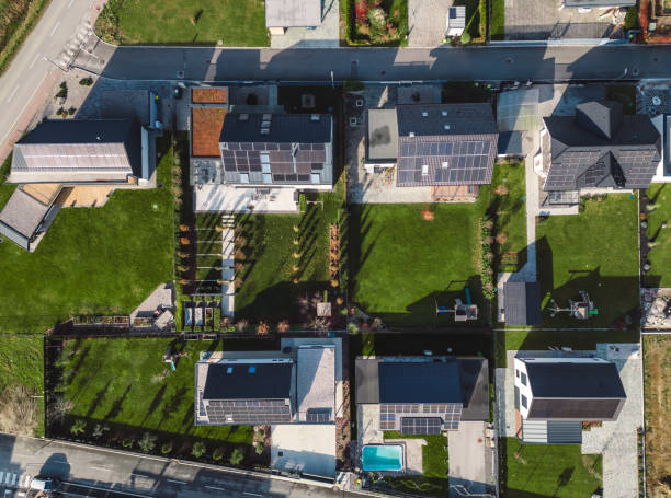 istock Low aerial close view new dense rural housing development, mostly grey roofing, some green landscaping, young trees. Modern homes with flat roof 1831282584