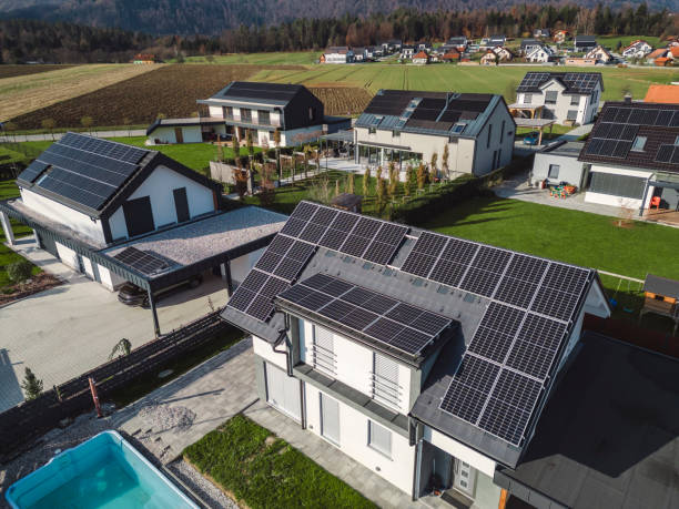 istock Low aerial close view new dense rural housing development, mostly grey roofing, some green landscaping, young trees. Modern homes with flat roof 1831283065