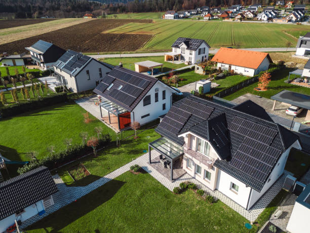 istock Low aerial close view new dense rural housing development, mostly grey roofing, some green landscaping, young trees. Modern homes with flat roof 1831283077