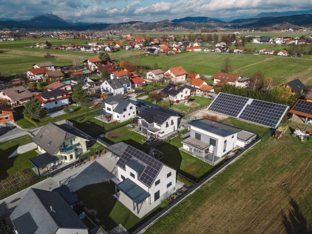 istock Low aerial close view new dense rural housing development, mostly grey roofing, some green landscaping, young trees. Modern homes with flat roof 1831283104