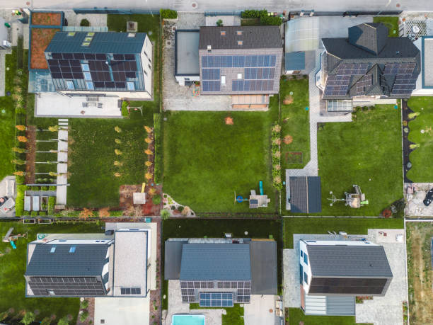 istock Low aerial close view new dense rural housing development, mostly grey roofing, some green landscaping, young trees. Modern homes with flat roof 1831283115