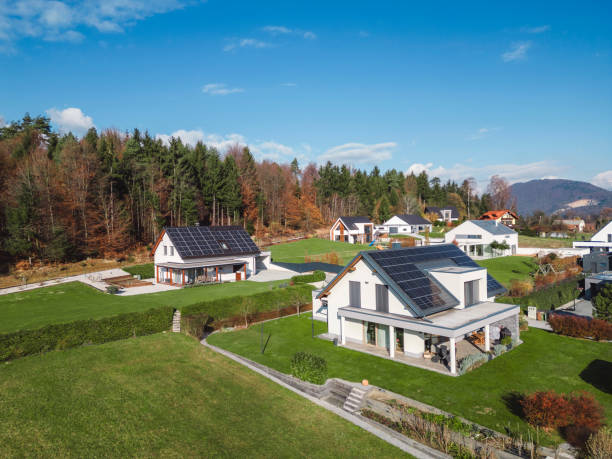 istock Low aerial close view new dense rural housing development, mostly grey roofing, some green landscaping, young trees. Modern homes with flat roof 1831283617