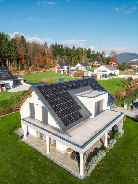 istock Low aerial close view new dense rural housing development, mostly grey roofing, some green landscaping, young trees. Modern homes with flat roof 1831283619