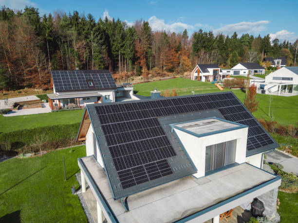 istock Low aerial close view new dense rural housing development, mostly grey roofing, some green landscaping, young trees. Modern homes with flat roof 1831283621