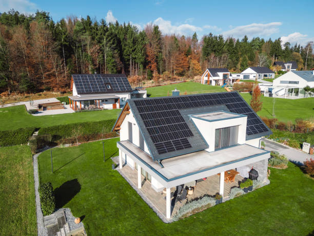 istock Low aerial close view new dense rural housing development, mostly grey roofing, some green landscaping, young trees. Modern homes with flat roof 1831283622