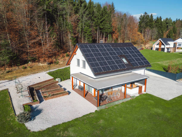 istock Low aerial close view new dense rural housing development, mostly grey roofing, some green landscaping, young trees. Modern homes with flat roof 1831283624