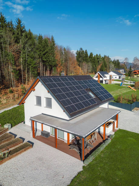 istock Low aerial close view new dense rural housing development, mostly grey roofing, some green landscaping, young trees. Modern homes with flat roof 1831283627
