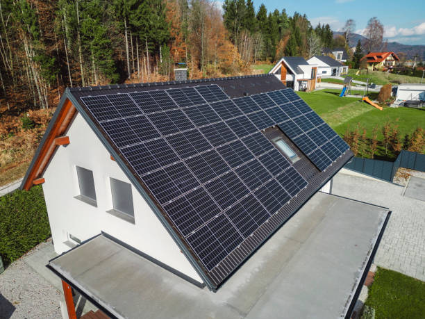 istock Low aerial close view new dense rural housing development, mostly grey roofing, some green landscaping, young trees. Modern homes with flat roof 1831284150