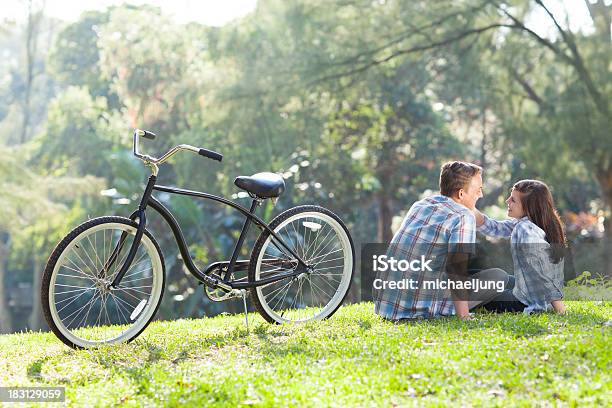 Teen Couple Sitting On The Grass Stock Photo - Download Image Now - Adolescence, Adult, Beautiful People