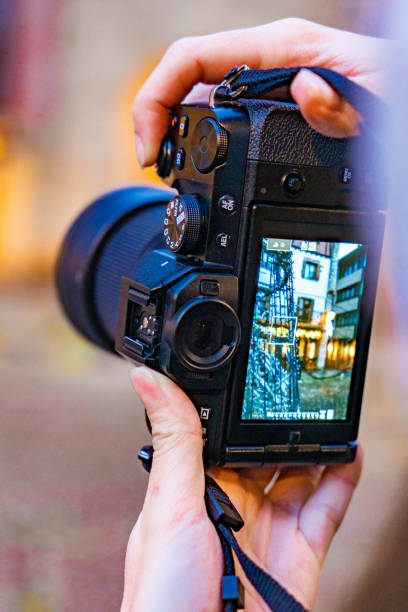 istock Close-up hands capturing city's holiday decorations with camera. 1831291031