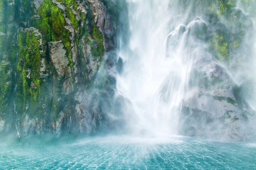 Waterfall with fluffy steam fall on the sea, Milford Sound, Southern Island, New Zealand