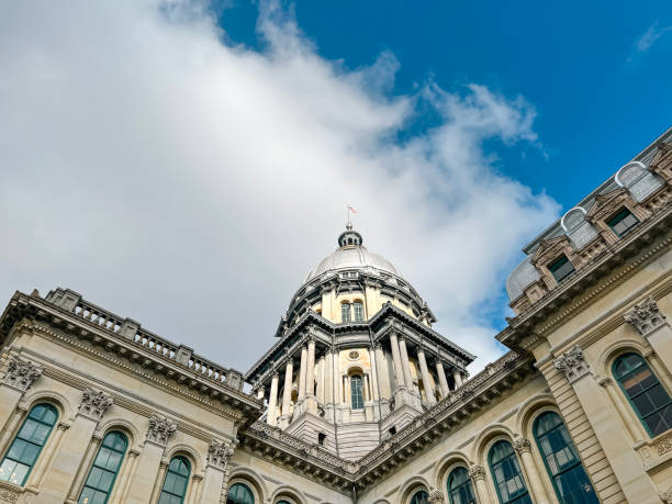 The Illinois State Capitol Building in Springfield, Illinois, USA Rear views of the Illinois State Capitol Building in Springfield, Illinois, USA. Cloudy blue skies overhead. Sunlight shines down upon the dome of the building. illinois state capitol stock pictures, royalty-free photos & images