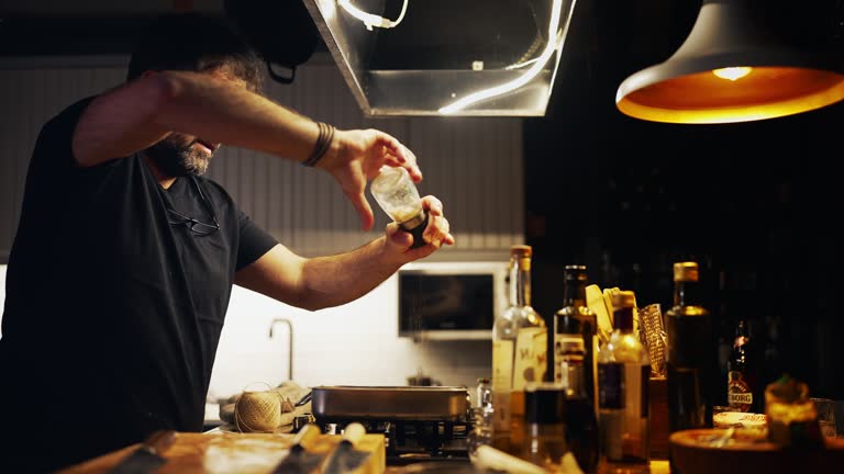 Man seasoning  the fish in tray