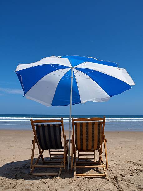 Montanita Ecuador - Beach Umbrellas Montanita Ecuador - Blue and White Beach Umbrellas and deck chairs montanita ecuador stock pictures, royalty-free photos & images