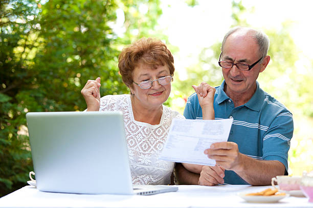 istock Happy senior couple looking at document 183136716