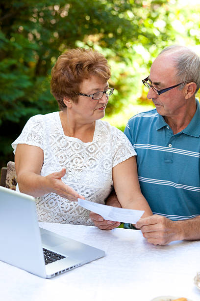 istock Happy senior couple looking at document 183136718