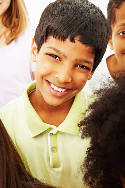 istock Multi ethnic boy with friends gives a cute smile 183136868