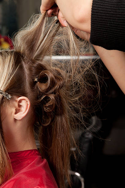 istock Stylist creating a formal hairstyle 183137052