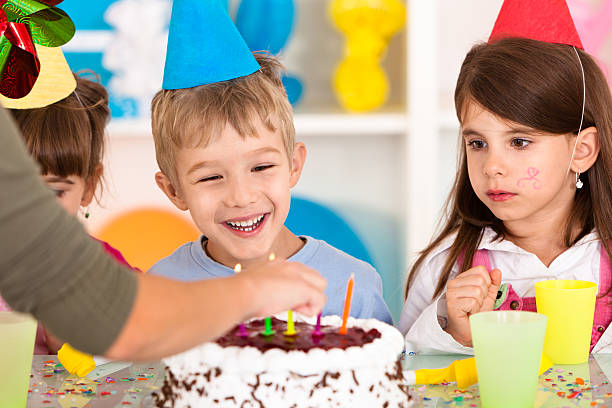 istock Lighting candles on birthday cake 183137586