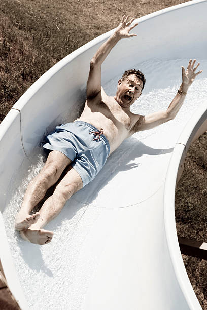 istock Fear on the face of man riding water slide 183138189