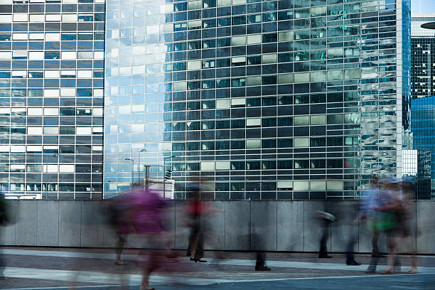 istock Blurred Commuters Walking in Front of an Office Building 183138752
