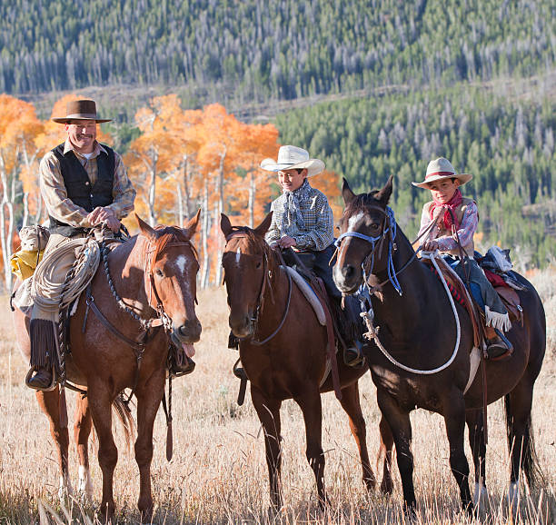 istock Father on horse with two young sons learning to ride 183138794