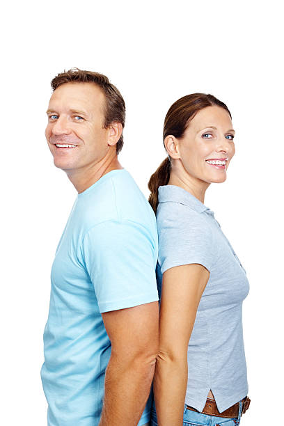 istock Smiling mature couple standing with backs against each other 183139234