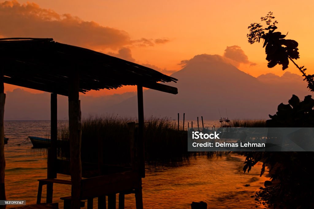 Sunset on Lake Atitlan, Guatemala Sunset on Lake Atitlan with San Pedro volcano in the background, Solola District, Santa Cruz La Laguna, Guatemala. Backgrounds Stock Photo