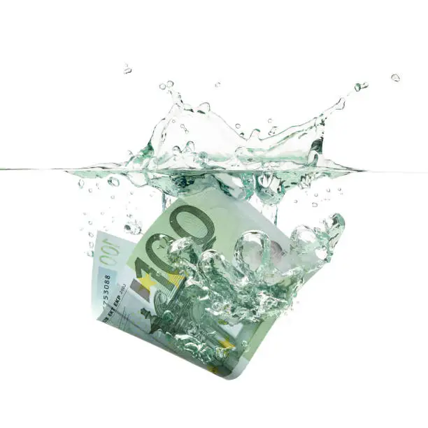 Photo of An euro bill splashing into the water as money depreciation