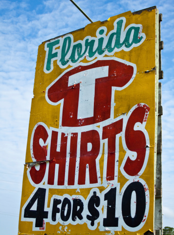 Very retro faded old Florida t-shirts sign. These colorful signs use to line the highways of old Florida and a few survive to this day.