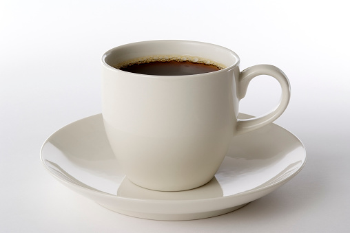 Close up shot of a cup of coffee isolated on white background.