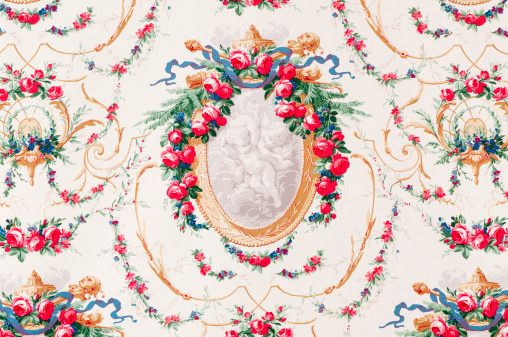 Antique  floral fabric with red rose garland decorating framed cherub image.Take a look at my LIGHTBOX of other related images.