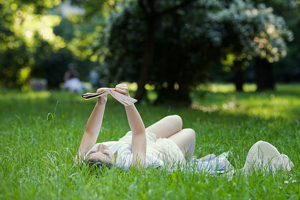 istock attractive girl sitting and reading book 183140585