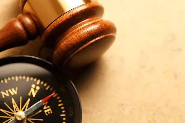 Photo of Gavel And Compass On Lightly Textured Surface