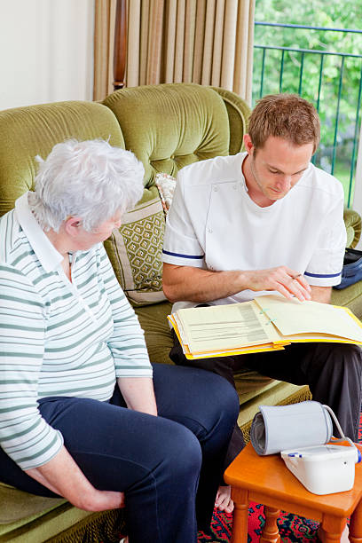 istock Nurse and senior lady chatting in care home 183140697