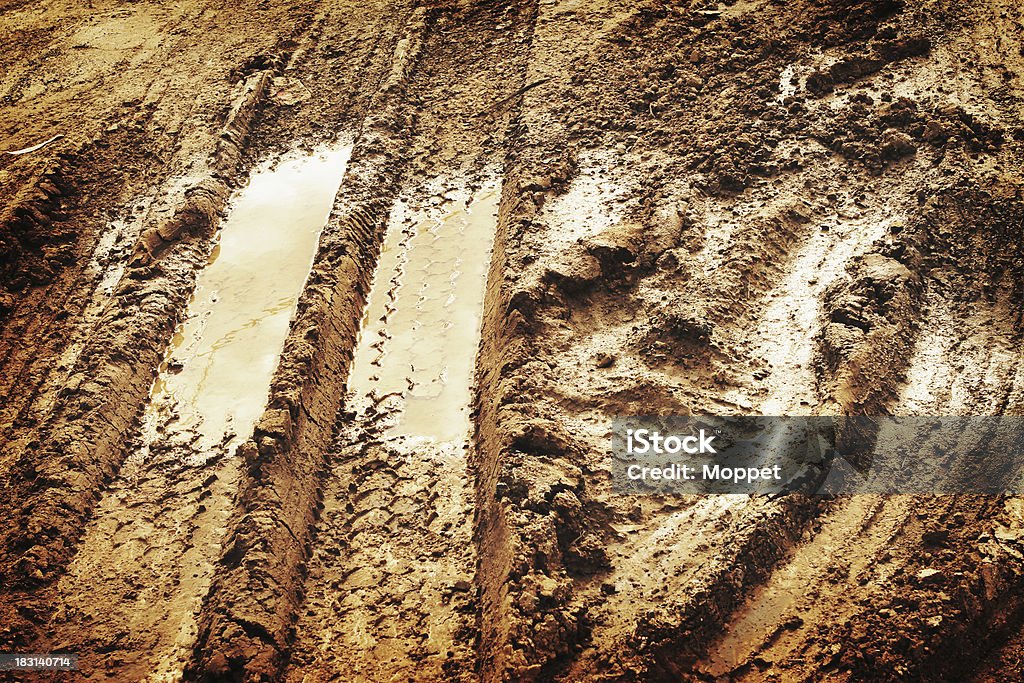 Muddy Track Tyre tracks through mud puddle. Horizontal Stock Photo