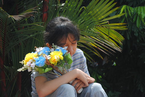 Teenage girl with a bouquet of flowers.