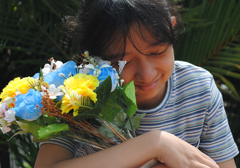 Teenage girl with a bouquet of flowers.