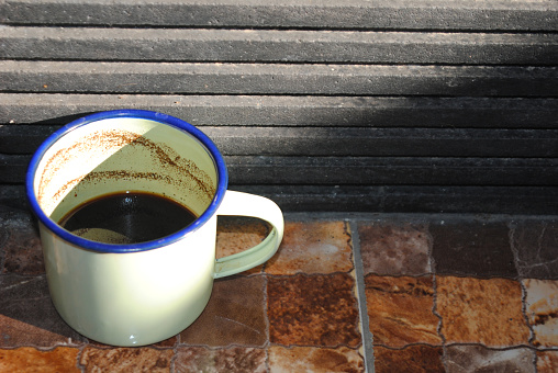 Enamelware classic metal coffee mug with negative space.