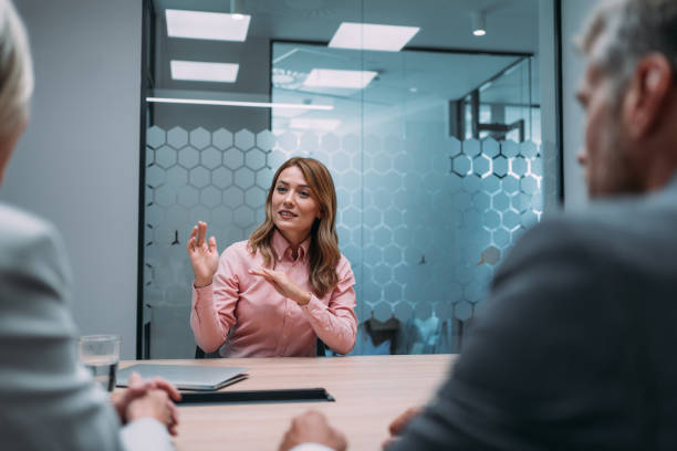 istock Group of business persons talking in the office. 1831418779