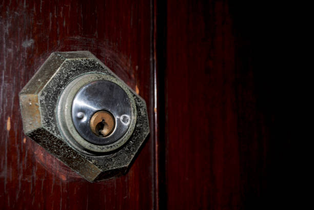 istock Image of keyhole in wooden door with negative space. 1831419325