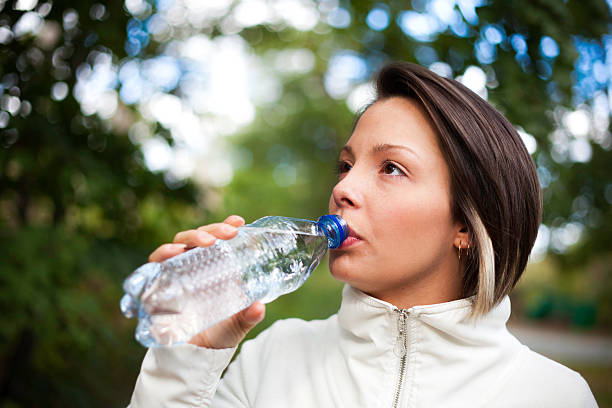 istock Active Young Woman Drinking Water Outdoors 183142488
