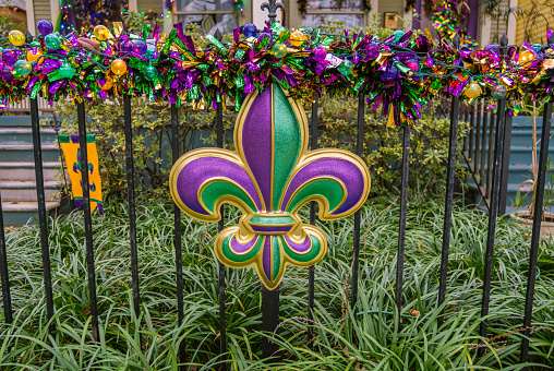 Mardi Gras decorations in the French Quarter in New Orleans in the colors of purple, gold and green.
