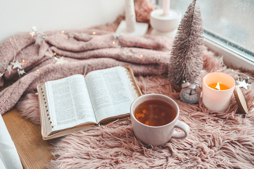 Cup of tea and open Bible, winter morning mood.