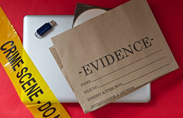 Internet cyber crime Closed laptop with a crime evidence bag,memory usb stick,dvd and a 'crime scene' banner. evidence bag stock pictures, royalty-free photos & images