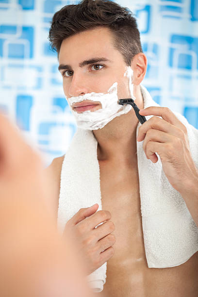 istock young man shaving in the bath 183148505