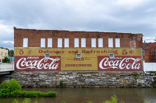 Pulaski Virginia - June 24 2023: The Facade of a Building With a Mural saying Drink Coca Cola on the Side of a Historic Building in Pulaski